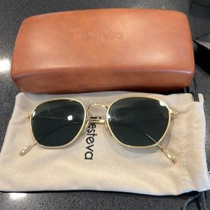 IllestEva Prince sunglasses in gold and black/green lens.